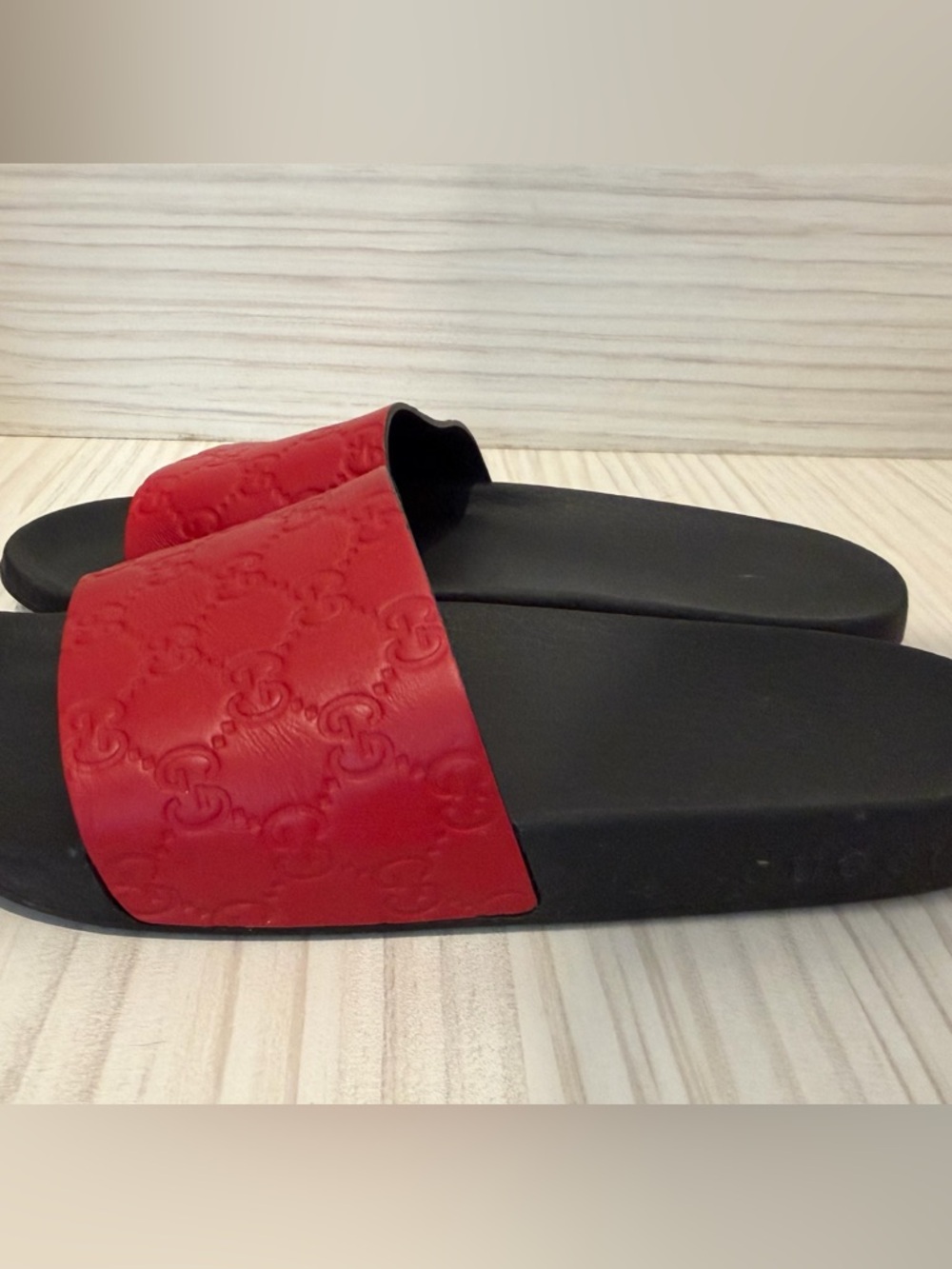Women’s red and black Gucci slides